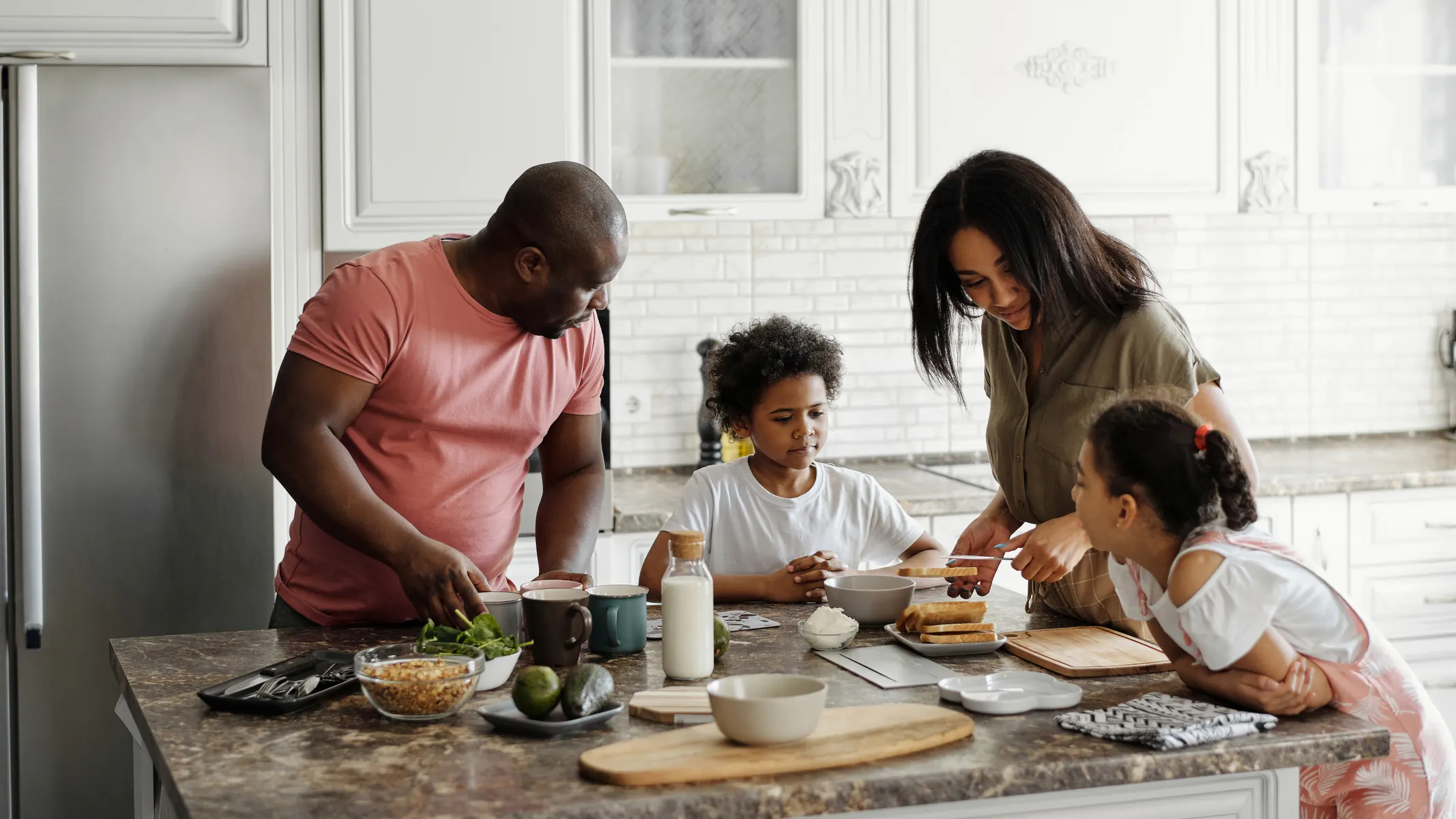 Family preparing a meal together at the kitchen table