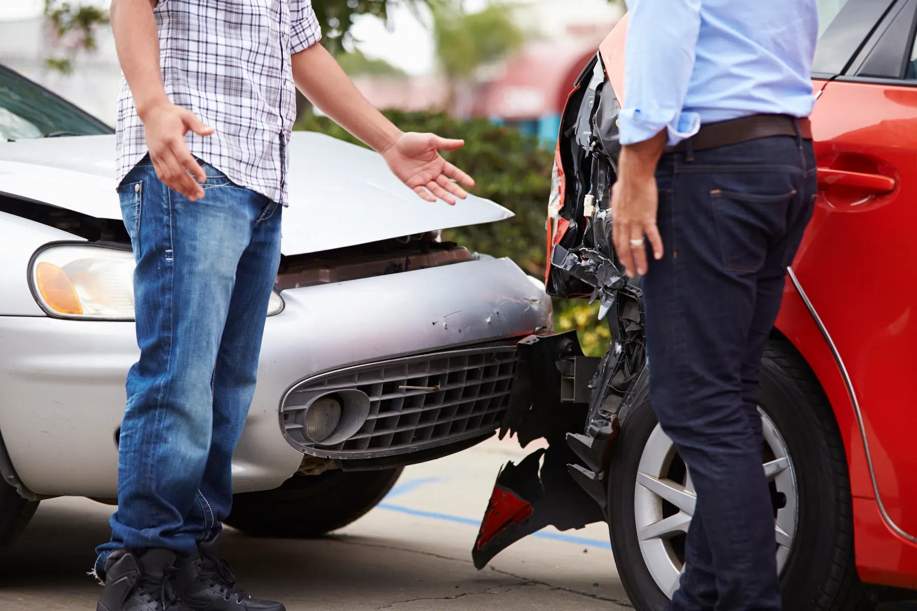 Two drivers discussing damage after a car accident