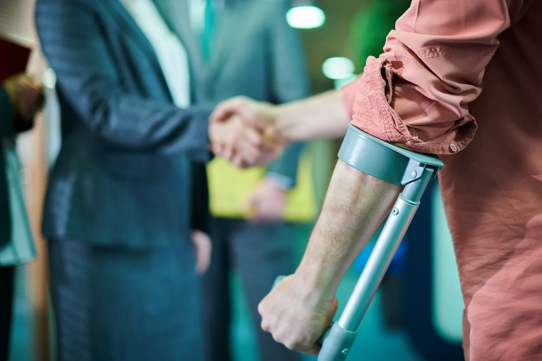 Handshake with a person using a crutch